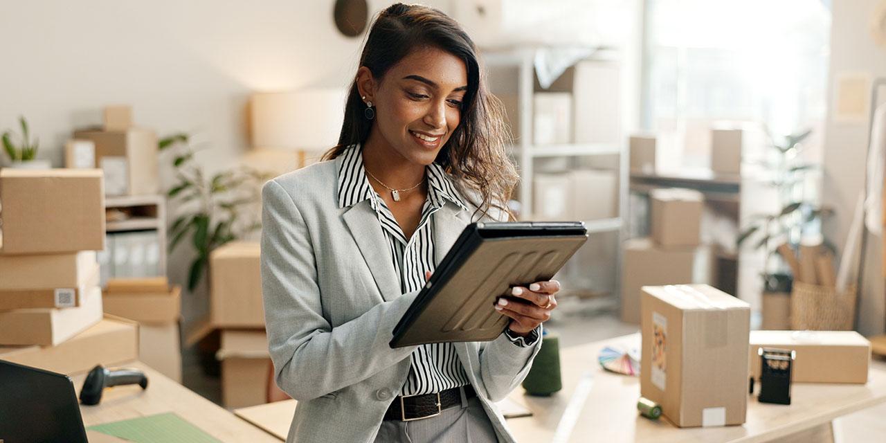 Woman setting up shipping on her tablet