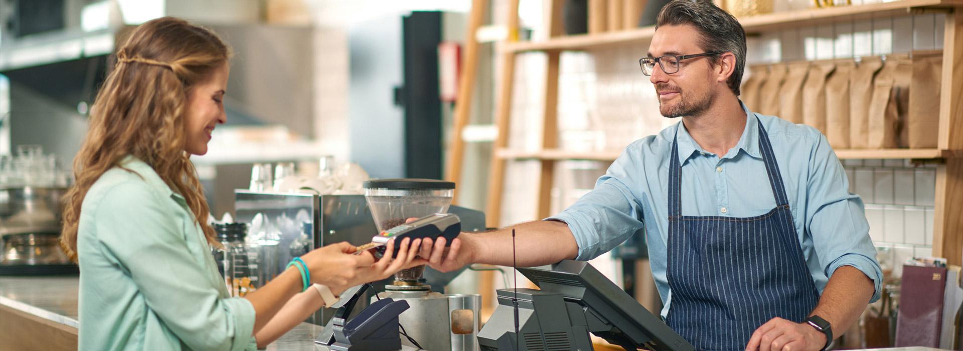 lady at counter paying for coffee