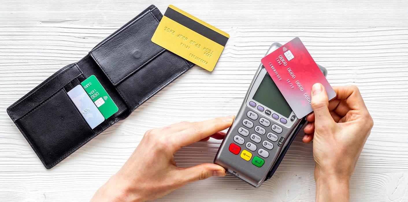 wallet, credit cards and calculator on a table