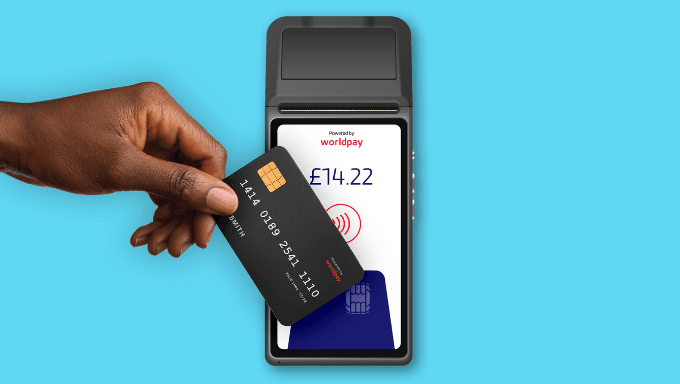 Hand inserting black payment card into card reader showing £14.22 Worldpay transaction on blue background.
