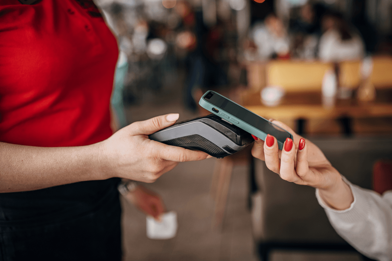 Person paying on a device with their phone
